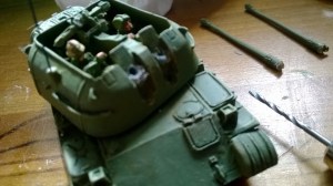 Use a pin vice to drill a hole into the mantlet. Attach wire or paper clip into hole. Using the same drill, make a hole in the barrels. Push together and glue