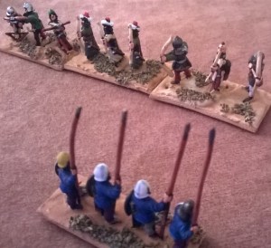 The moors mass their crossbows against the stout Christian spearmen.
